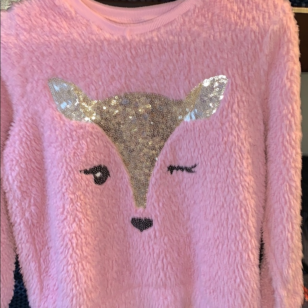 It is a sweater and it is fuzzy material